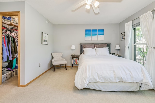560 2nd St Unit 114, Minneapolis, MN 55401 - bedroom with light colored carpet, baseboards, a spacious closet, a ceiling fan, and a closet