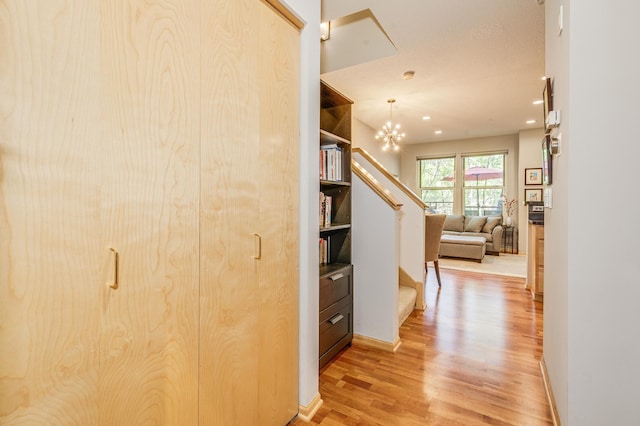 560 2nd St Unit 114, Minneapolis, MN 55401 - hallway featuring light wood-type flooring, stairs, recessed lighting, and a chandelier