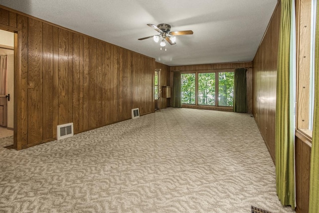 1700 Case Ave E, Saint Paul, MN 55106 - carpeted empty room with wooden walls and ceiling fan