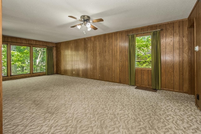 1700 Case Ave E, Saint Paul, MN 55106 - carpeted empty room featuring ceiling fan and wood walls
