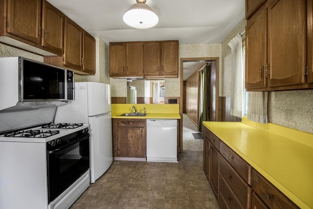 1700 Case Ave E, Saint Paul, MN 55106 - kitchen featuring dishwasher, range with gas stovetop, light countertops, a sink, and brown cabinets