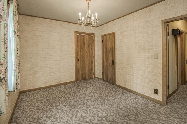1700 Case Ave E, Saint Paul, MN 55106 - empty room with crown molding, carpet floors, a chandelier, and baseboards