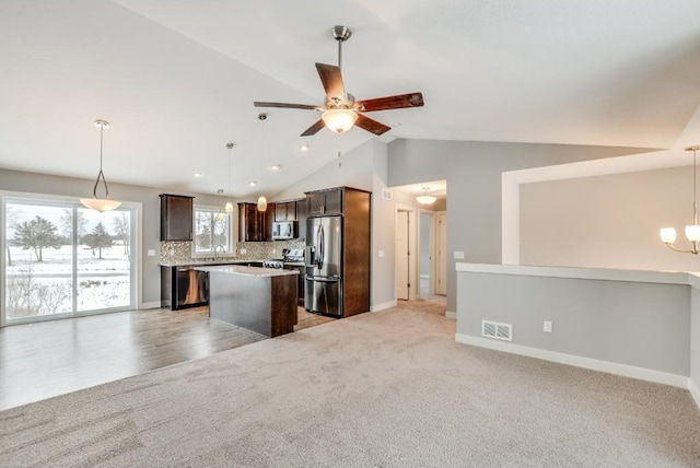 4781 261st St, Wyoming, MN 55092 - kitchen featuring appliances with stainless steel finishes, open floor plan, a center island, lofted ceiling, and a ceiling fan
