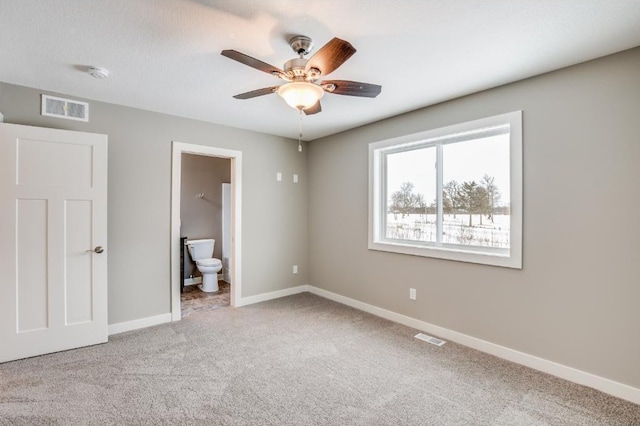 4781 261st St, Wyoming, MN 55092 - unfurnished bedroom featuring carpet, baseboards, connected bathroom, and ceiling fan