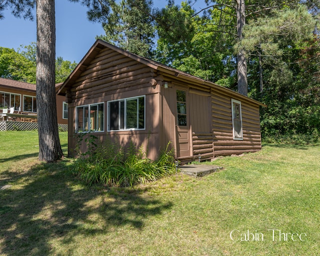 1409 Wabedo Pass Rd NE, Longville, MN 56655 - view of front of home featuring a front lawn and log exterior