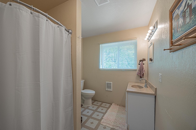 1409 Wabedo Pass Rd NE, Longville, MN 56655 - full bathroom with tile patterned floors, toilet, vanity, heating unit, and a textured wall