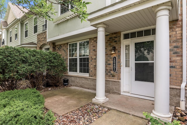 15481 Frost Path Unit 1803, Apple Valley, MN 55124 - view of exterior entry with a porch, brick siding, and stone siding