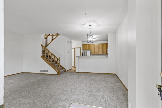 15481 Frost Path Unit 1803, Apple Valley, MN 55124 - unfurnished living room featuring light colored carpet, stairway, and a chandelier