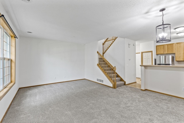 15481 Frost Path Unit 1803, Apple Valley, MN 55124 - unfurnished living room featuring light colored carpet and stairs