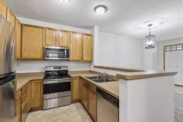 15481 Frost Path Unit 1803, Apple Valley, MN 55124 - kitchen featuring appliances with stainless steel finishes, a peninsula, a textured ceiling, hanging light fixtures, and brown cabinetry