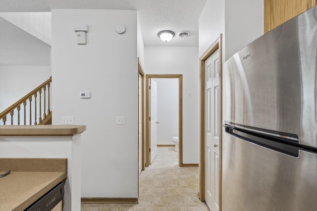 15481 Frost Path Unit 1803, Apple Valley, MN 55124 - kitchen featuring freestanding refrigerator, a textured ceiling, and dishwashing machine