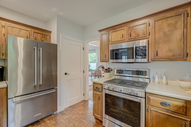 8517 143rd St W, Apple Valley, MN 55124 - kitchen with appliances with stainless steel finishes, light countertops, and brown cabinetry