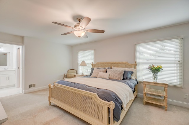 8517 143rd St W, Apple Valley, MN 55124 - bedroom with a sink, light carpet, baseboards, ceiling fan, and connected bathroom