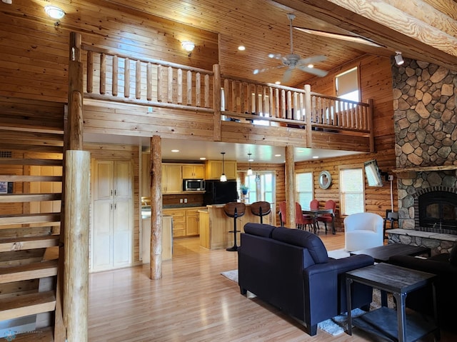 25712 15th Ave N, Highland Grove Twp, MN 56549 - living room with a towering ceiling, a ceiling fan, light wood-type flooring, and a fireplace