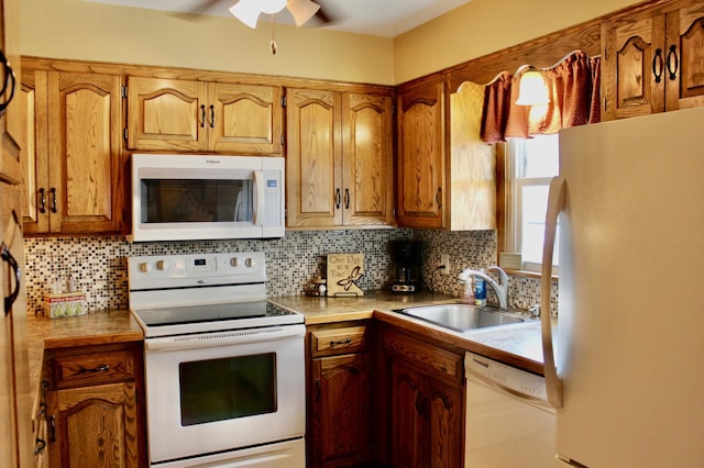 606 Center Ave N, Blooming Prairie, MN 55917 - kitchen featuring white appliances, a sink, backsplash, and a ceiling fan