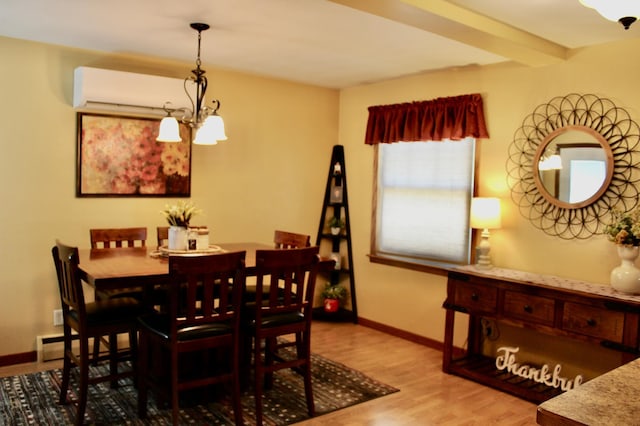 606 Center Ave N, Blooming Prairie, MN 55917 - dining space featuring a chandelier, baseboards, wood finished floors, and a wall mounted AC
