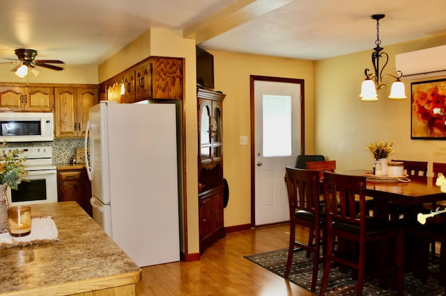 606 Center Ave N, Blooming Prairie, MN 55917 - dining space with a ceiling fan, light wood-style floors, and a chandelier