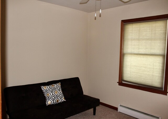 606 Center Ave N, Blooming Prairie, MN 55917 - living area featuring a baseboard radiator, carpet floors, a ceiling fan, and baseboards