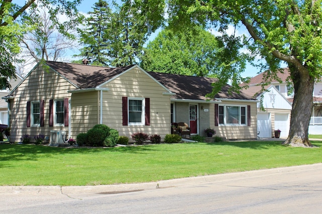 606 Center Ave N, Blooming Prairie, MN 55917 - view of front of home with a garage and a front lawn