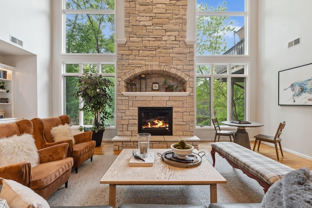600 Sibley Ct, Mendota Heights, MN 55118 - living area with a towering ceiling, a stone fireplace, and wood finished floors