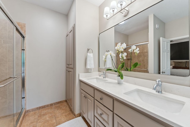 600 Sibley Ct, Mendota Heights, MN 55118 - bathroom with double vanity, a tile shower, tile patterned flooring, and baseboards