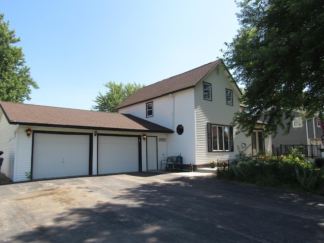 909 6th Ave, Brewster, MN 56119 - traditional-style home with a shingled roof, an attached garage, and driveway