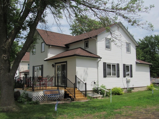 909 6th Ave, Brewster, MN 56119 - rear view of property with roof with shingles, a yard, and a wooden deck