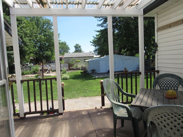 909 6th Ave, Brewster, MN 56119 - view of patio with outdoor dining space, a pergola, and a storage unit
