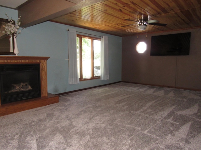 909 6th Ave, Brewster, MN 56119 - unfurnished living room featuring carpet floors, a ceiling fan, wooden ceiling, and a fireplace with raised hearth