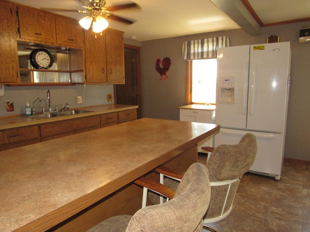 909 6th Ave, Brewster, MN 56119 - kitchen with white fridge with ice dispenser, brown cabinets, ceiling fan, light countertops, and open shelves