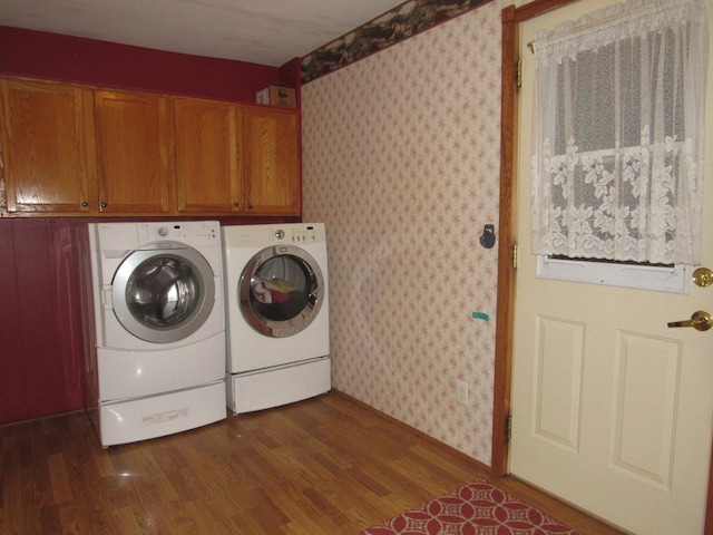 909 6th Ave, Brewster, MN 56119 - washroom with wallpapered walls, washing machine and dryer, cabinet space, and dark wood-style floors