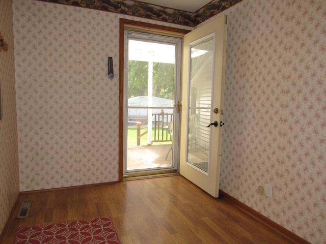 909 6th Ave, Brewster, MN 56119 - doorway featuring wood finished floors and baseboards