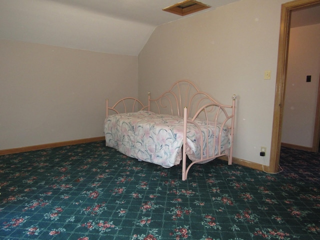909 6th Ave, Brewster, MN 56119 - carpeted bedroom featuring vaulted ceiling and baseboards