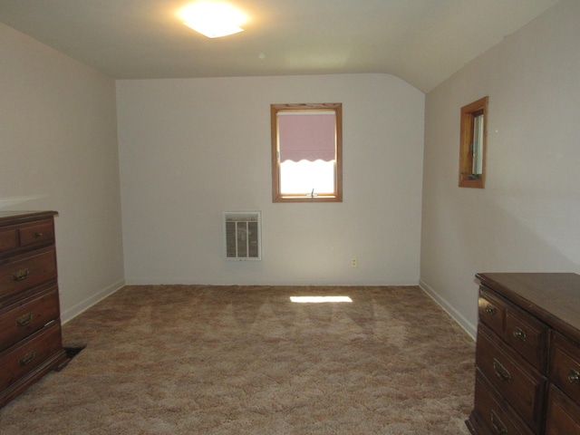 909 6th Ave, Brewster, MN 56119 - unfurnished bedroom featuring carpet flooring and lofted ceiling