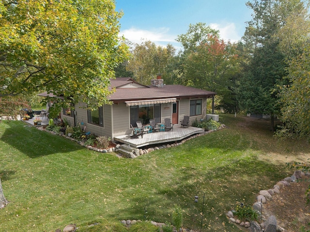 6823 Re Echo Ridge Dr NE, Remer, MN 56672 - back of property with a wooden deck, a yard, and a chimney