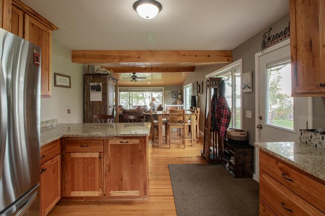 6823 Re Echo Ridge Dr NE, Remer, MN 56672 - kitchen with freestanding refrigerator, a peninsula, light wood finished floors, beam ceiling, and a ceiling fan