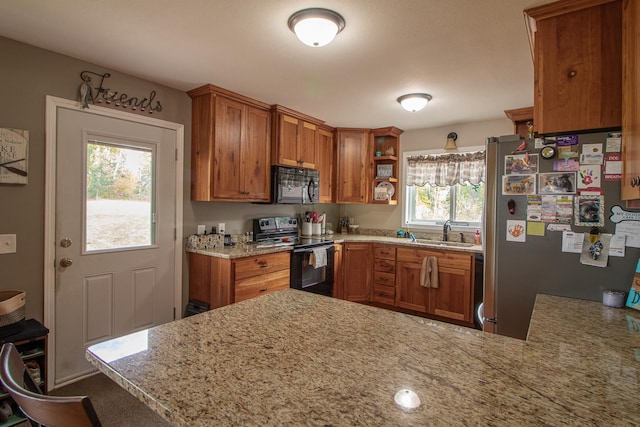 6823 Re Echo Ridge Dr NE, Remer, MN 56672 - kitchen with black appliances, brown cabinetry, a sink, and open shelves