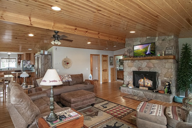 6823 Re Echo Ridge Dr NE, Remer, MN 56672 - living area with wooden ceiling, a stone fireplace, a ceiling fan, wood finished floors, and recessed lighting