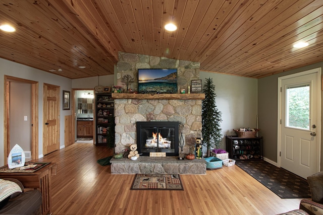 6823 Re Echo Ridge Dr NE, Remer, MN 56672 - living room with vaulted ceiling, baseboards, a stone fireplace, wood finished floors, and wooden ceiling