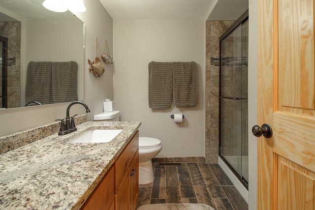 6823 Re Echo Ridge Dr NE, Remer, MN 56672 - bathroom with vanity, toilet, and a stall shower