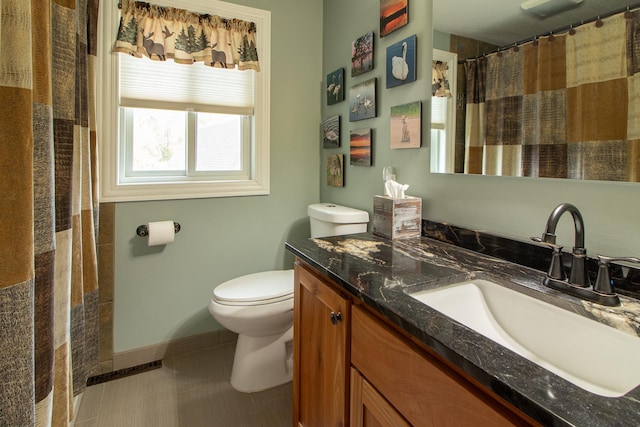 6823 Re Echo Ridge Dr NE, Remer, MN 56672 - bathroom with toilet, vanity, baseboards, and tile patterned flooring