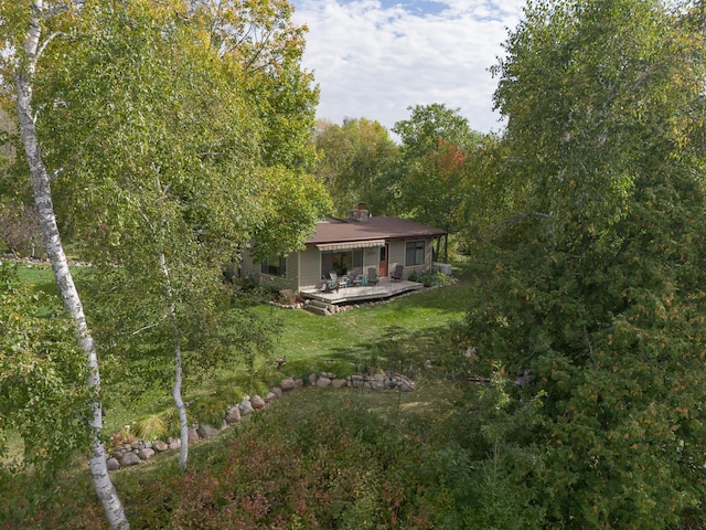 6823 Re Echo Ridge Dr NE, Remer, MN 56672 - back of house with a lawn, a chimney, and a deck