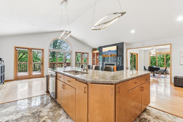 2665 Oriole Ave N, West Lakeland Twp, MN 55082 - kitchen featuring plenty of natural light, a sink, open floor plan, a kitchen island with sink, and lofted ceiling