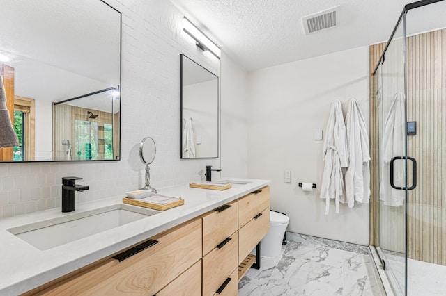 2665 Oriole Ave N, West Lakeland Twp, MN 55082 - bathroom featuring marble look tiles, a shower stall, double vanity, toilet, and a textured ceiling