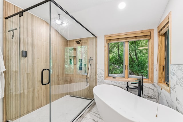 2665 Oriole Ave N, West Lakeland Twp, MN 55082 - bathroom with marble tiled floors, a freestanding bath, a stall shower, and tile walls