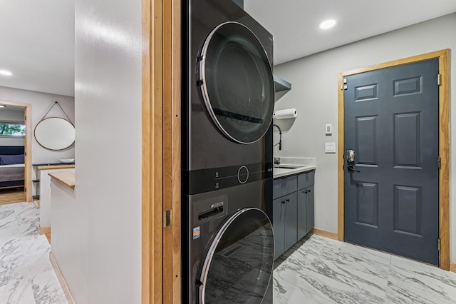 2665 Oriole Ave N, West Lakeland Twp, MN 55082 - laundry room with stacked washer / drying machine, light marble finish floors, cabinet space, recessed lighting, and baseboards