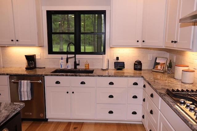 5004 W Rd, Silver Twp, MN 55767 - kitchen featuring appliances with stainless steel finishes, a sink, range hood, and white cabinets