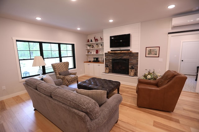 5004 W Rd, Silver Twp, MN 55767 - living area featuring a wall mounted air conditioner, light wood-type flooring, a fireplace, recessed lighting, and baseboards