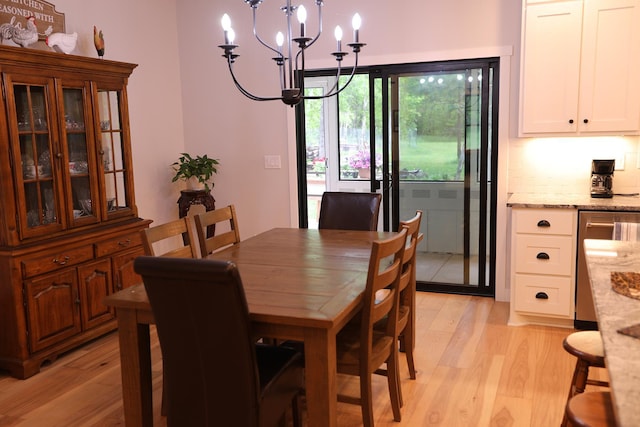 5004 W Rd, Silver Twp, MN 55767 - dining space with a chandelier and light wood-style floors