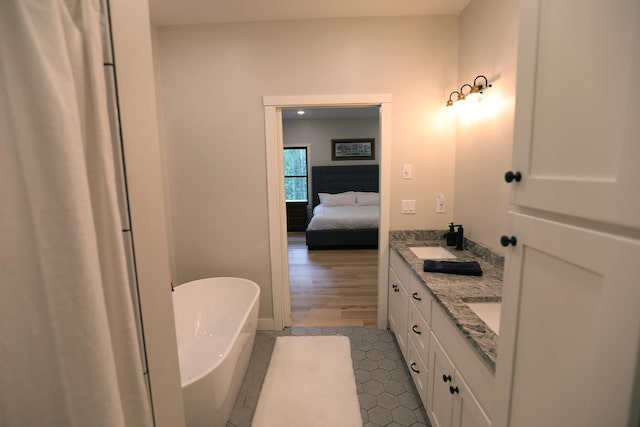 5004 W Rd, Silver Twp, MN 55767 - bathroom with double vanity, a soaking tub, tile patterned floors, and ensuite bath